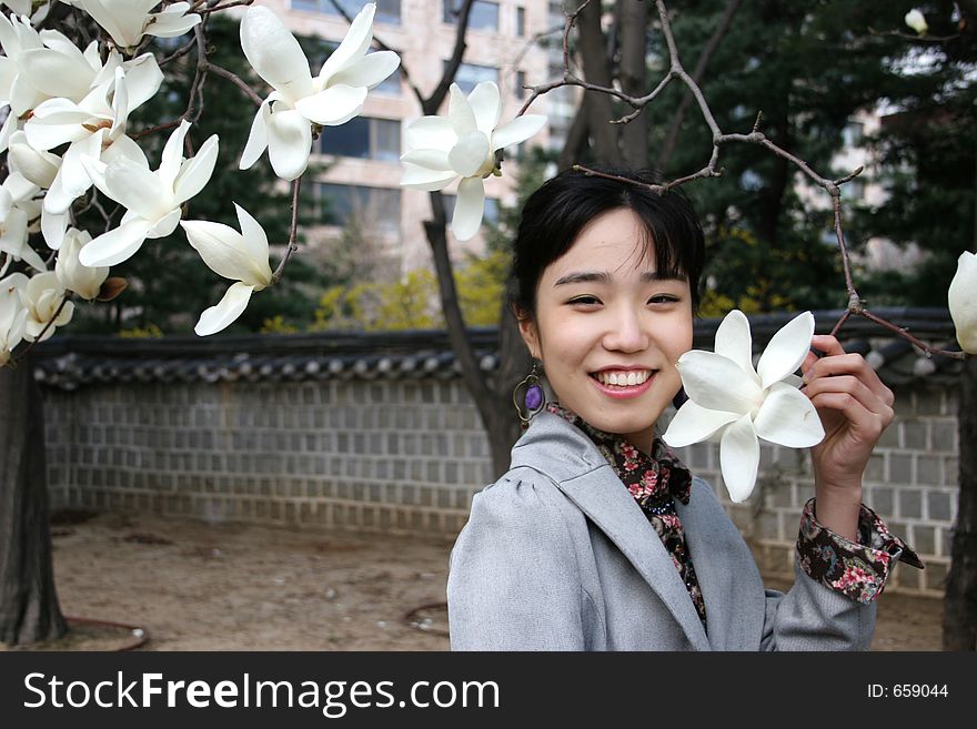 Pretty Korean woman holding a flower. Pretty Korean woman holding a flower