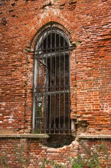 Ancient Brick Wall With Window And Iron Lattice Royalty Free Stock Photo