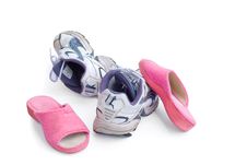 A Pair Of Sneakers And Pink Slippers Royalty Free Stock Images