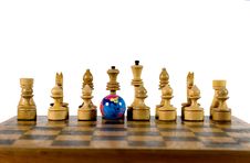 Globe And Wooden Chess Figures Royalty Free Stock Images