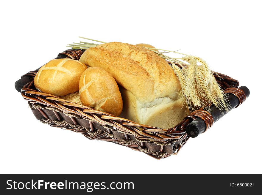 Basket of wheat bread, buns and wheat ears. Basket of wheat bread, buns and wheat ears.