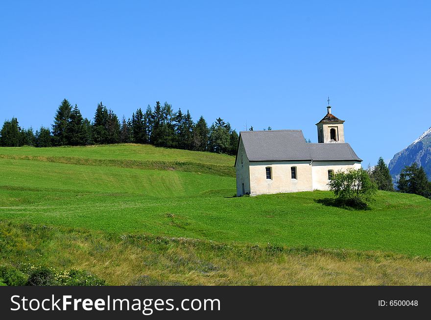 Picturesque landscape featuring an old church in the swiss alps. Picturesque landscape featuring an old church in the swiss alps