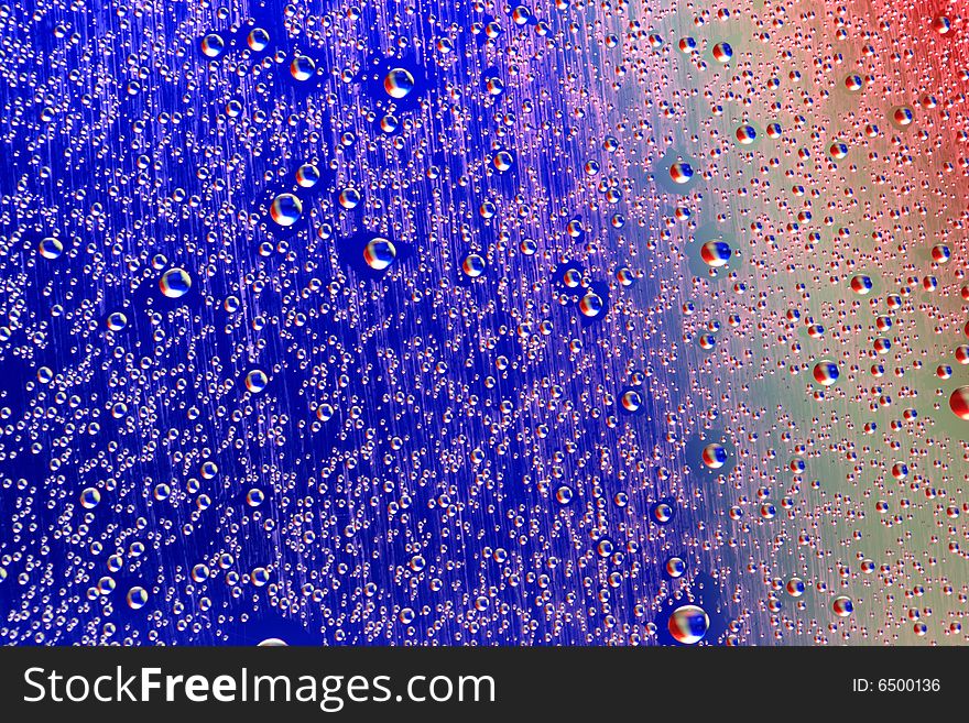 Drops of water on a blue, lila background. Drops of water on a blue, lila background.