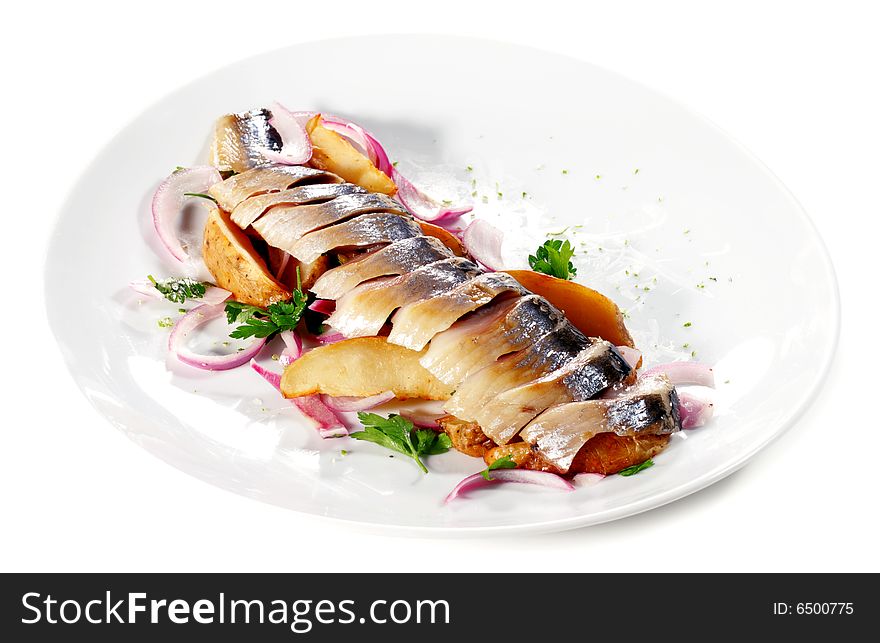 Sliced Fish Served with Baked Potatoes, Green and Onion. Isolated on White Background. Sliced Fish Served with Baked Potatoes, Green and Onion. Isolated on White Background