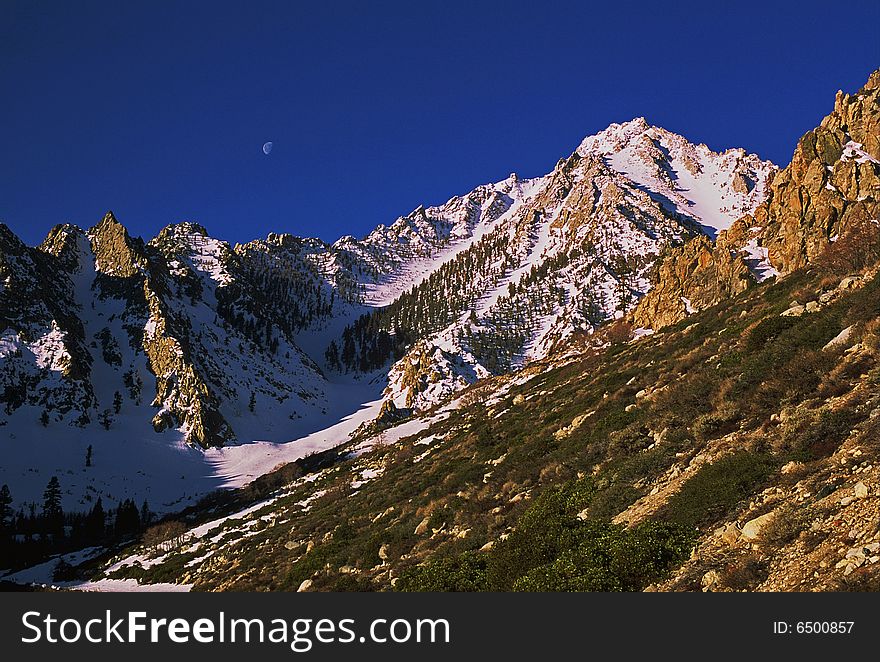 Snowy mountain peak with moon. Snowy mountain peak with moon