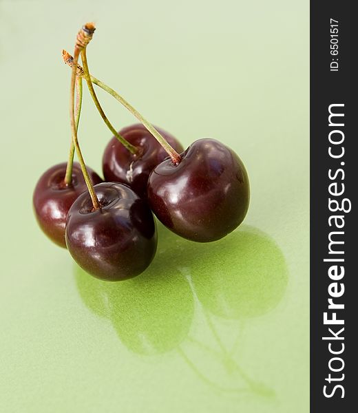 Two cherries isolated on green. Two cherries isolated on green