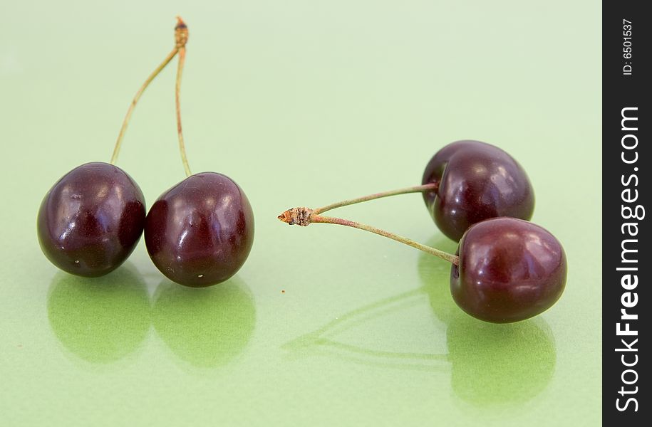 Two cherries isolated on green. Two cherries isolated on green