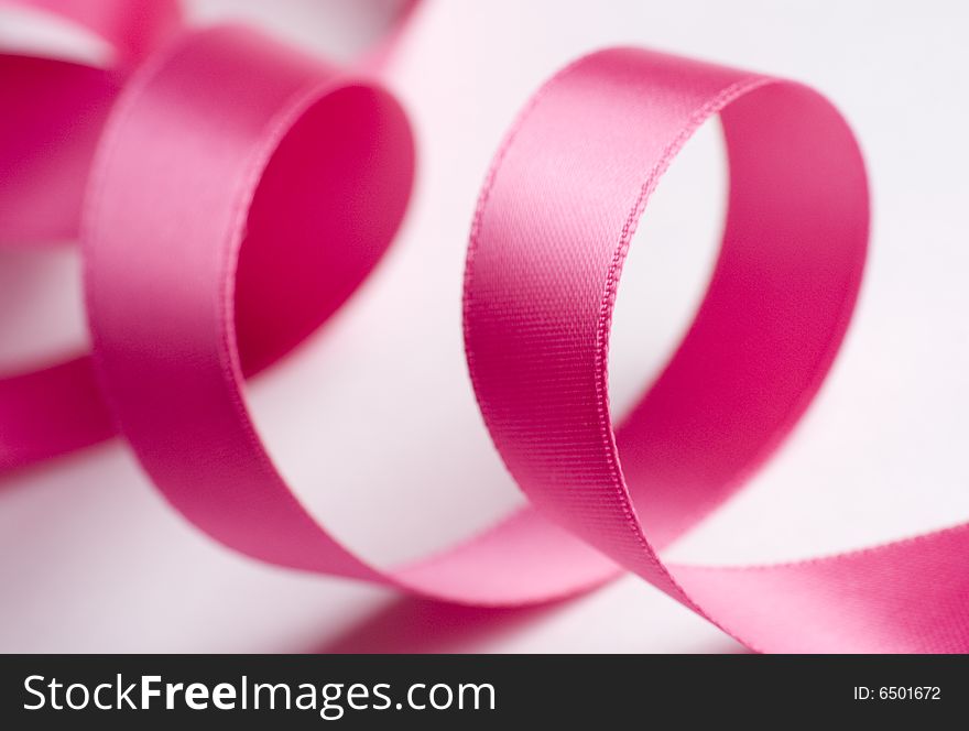 Pink Ribbon Curling on White. Pink Ribbon Curling on White