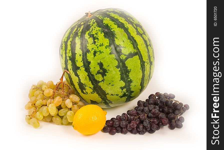 Watermelon and grapes with a lemon fruit on white background. Watermelon and grapes with a lemon fruit on white background