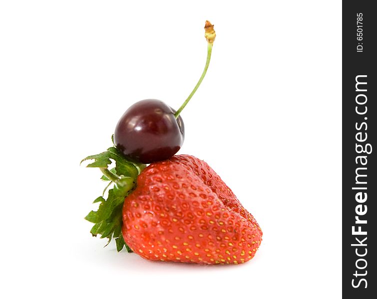 Cherry on strawberry isolated on white. Cherry on strawberry isolated on white