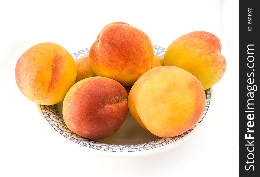 Several peaches isolated on white