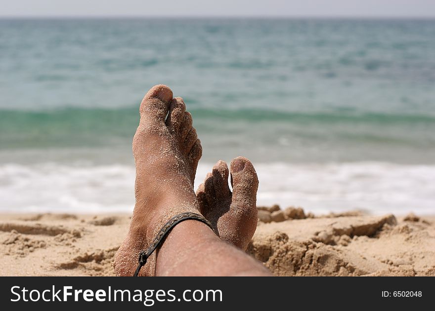 Two feet relaxing by the sea. Two feet relaxing by the sea