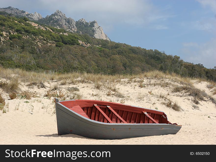 A stranded boat on a deserted beach in Cadiz, South of Spain. A stranded boat on a deserted beach in Cadiz, South of Spain