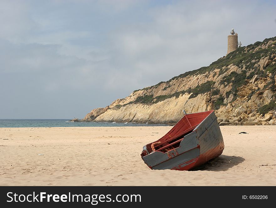 A stranded boat on a deserted beach in Cadiz, South of Spain. A stranded boat on a deserted beach in Cadiz, South of Spain