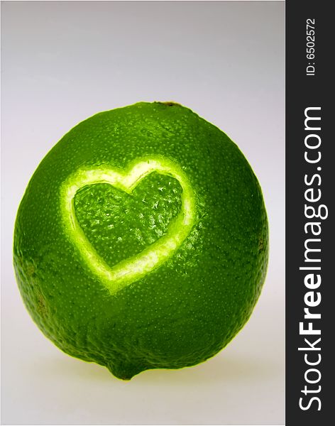 A lime with a heart carved into its skin. A lime with a heart carved into its skin
