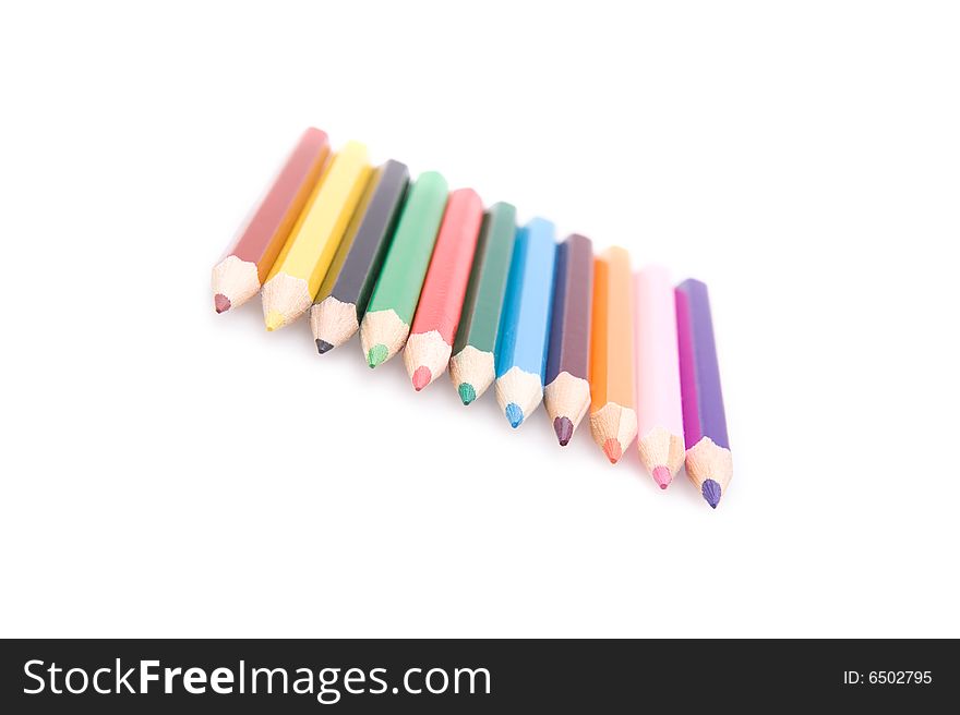 Closeup of a row of bright color pencils. Isolated on white. Closeup of a row of bright color pencils. Isolated on white.