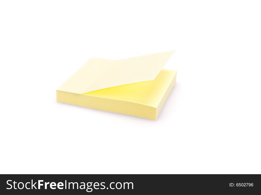 Closeup of a pad of yellow sticky notes. Isolated on white. Closeup of a pad of yellow sticky notes. Isolated on white.