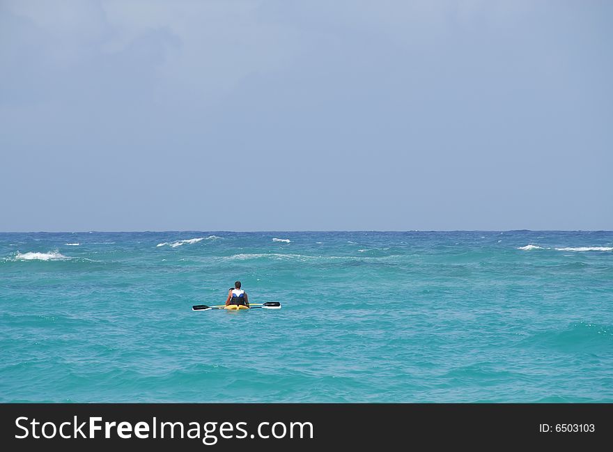 People in a canoe paddle (kayak), the Caribbean Sea