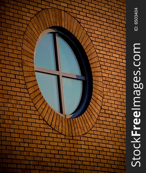 A circular window on a brick building. A circular window on a brick building.