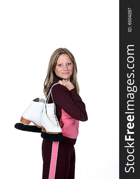 Pretty woman in pink holding her figure skates over her shoulder like she's heading to practice. Pretty woman in pink holding her figure skates over her shoulder like she's heading to practice