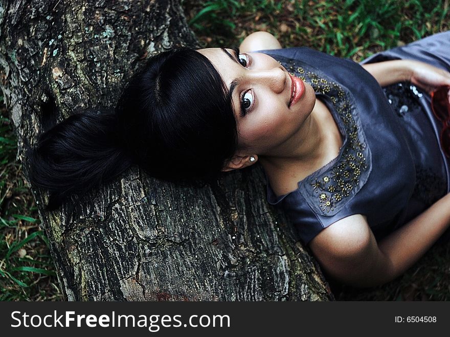 Glamorous beautiful young asian woman lying down