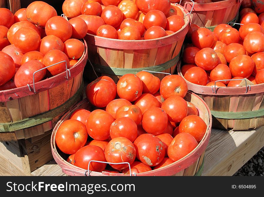 Tomatoes in baskets at the farm stand