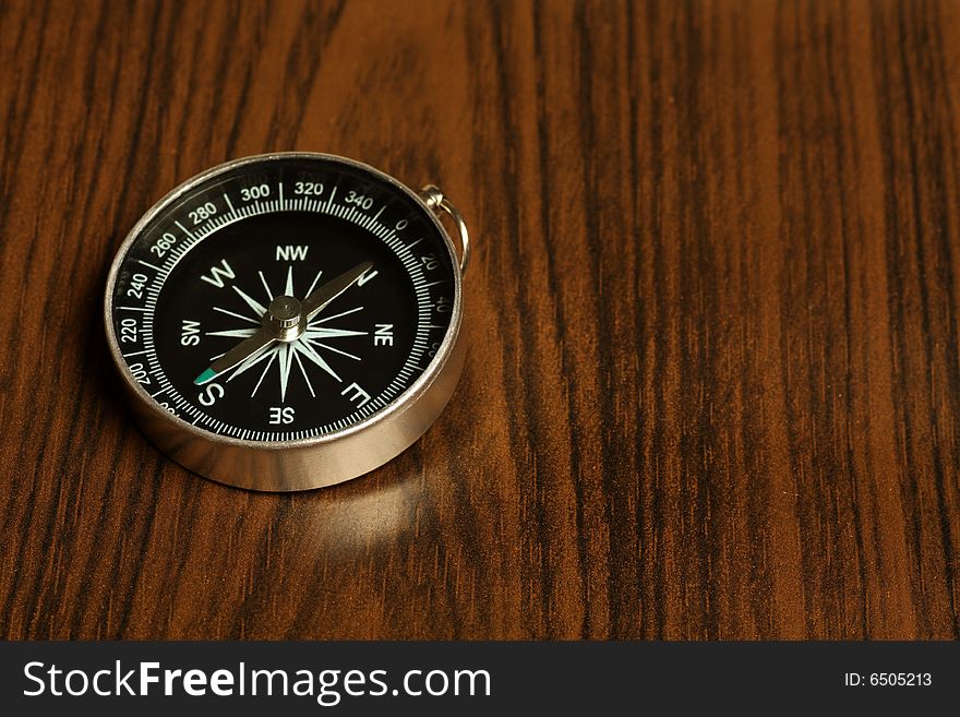 Magnetic Compass On A Wooden Background