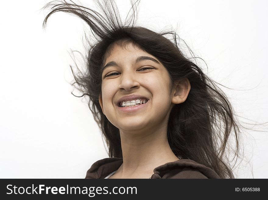 Beautiful young girl smiling with hair blowing. Beautiful young girl smiling with hair blowing