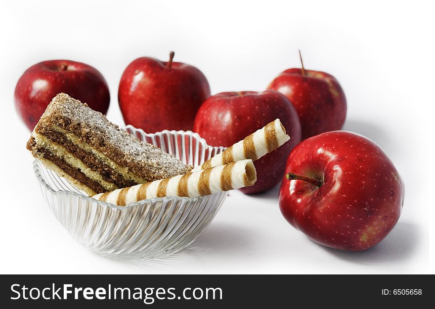 Red apples Cakes in bowl and red apples on white background. Red apples Cakes in bowl and red apples on white background