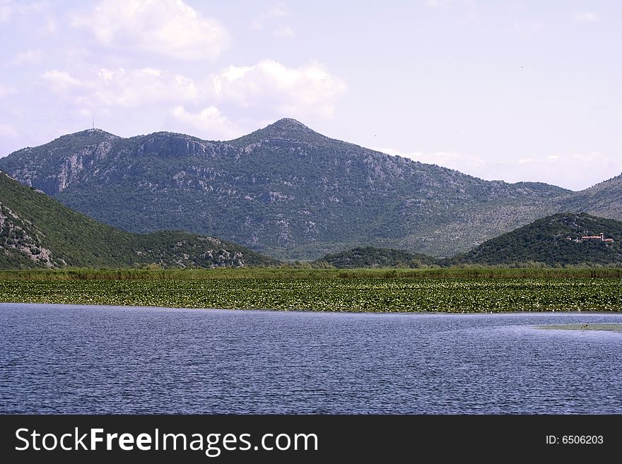 Nice picture of european lakewith water lilies near the mountains. Nice picture of european lakewith water lilies near the mountains