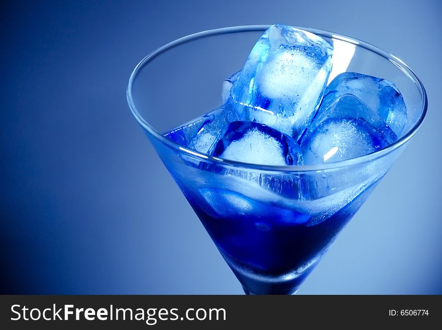 Ice Cube in Martini Glass with blue gradient background