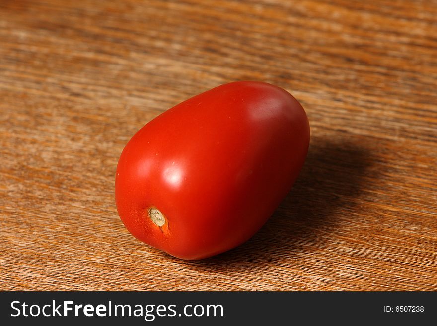 Landscape solitary tomato on timber table