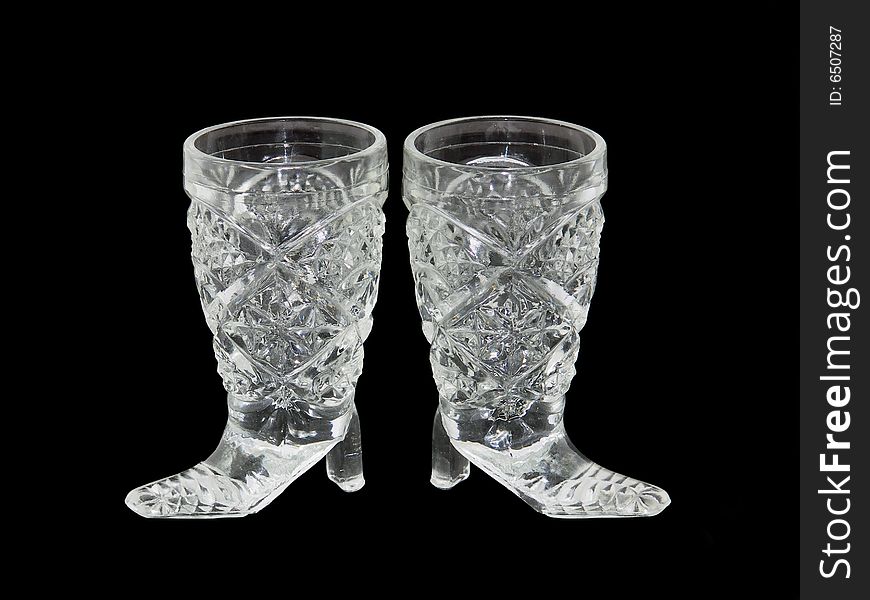 Two wine-glasses from crystal isolated on a black background