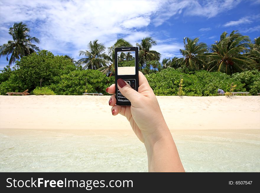 Woman taking picture of exotic beach with mobile phone. Woman taking picture of exotic beach with mobile phone
