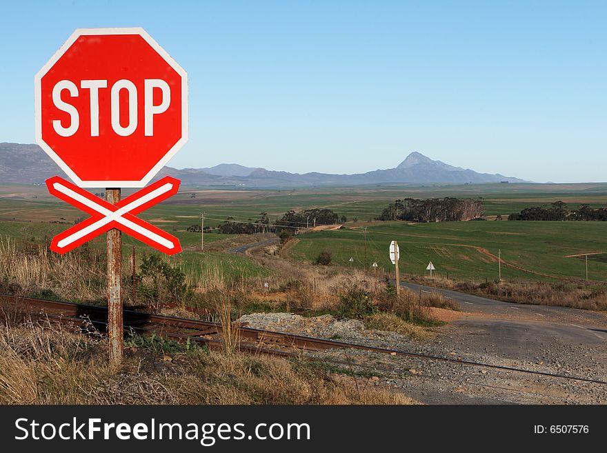 A stop sign at a rail road crossing