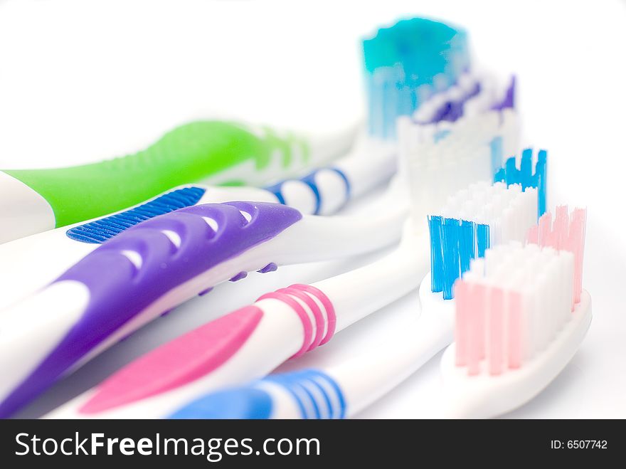 Five new toothbrushes multicolored, isolated