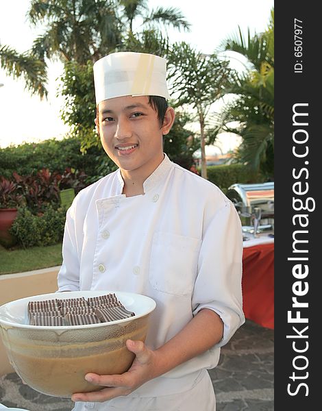 Chaf holding pastry food at buffet. Chaf holding pastry food at buffet