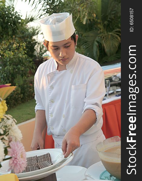 Chef holding pastry food at buffet. Chef holding pastry food at buffet