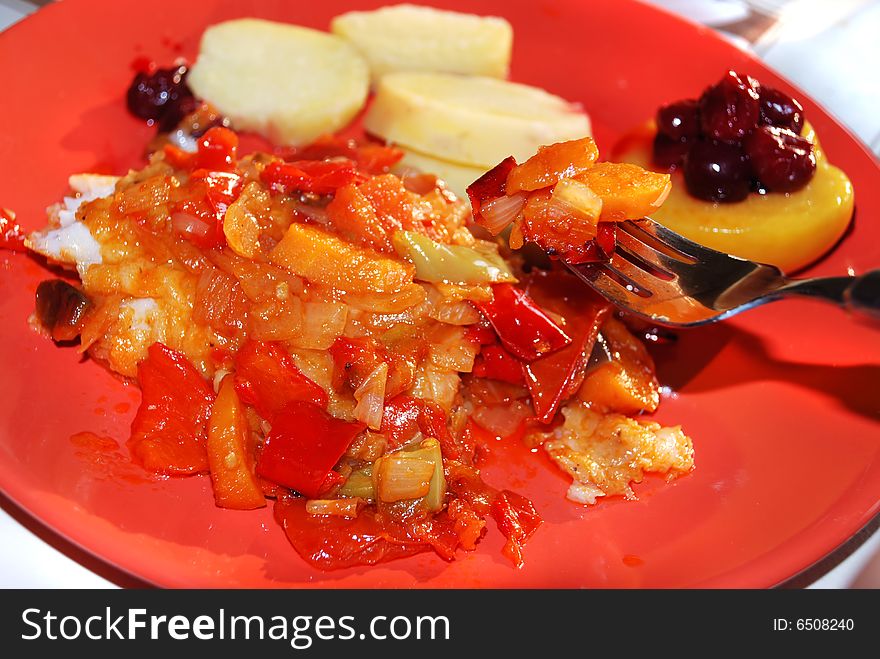 Fried vegetables on red plate with fork. Fried vegetables on red plate with fork
