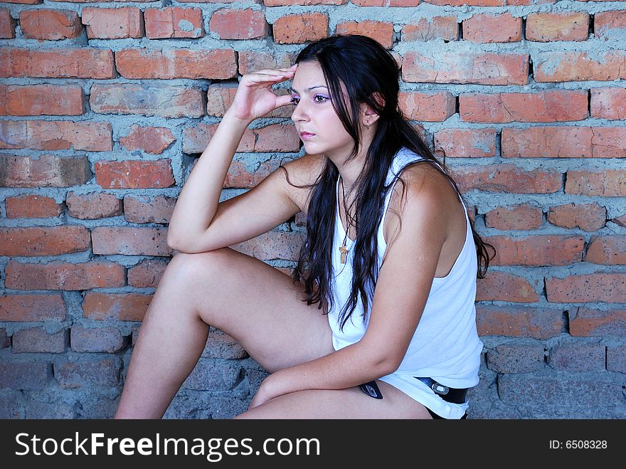 The girl near a brick wall