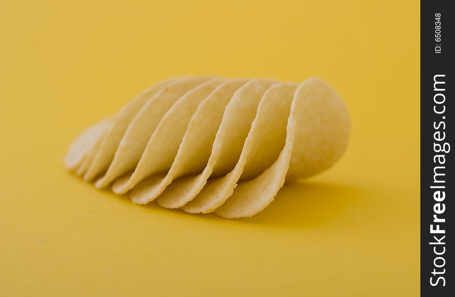 Chips close-up isolated on yellow background