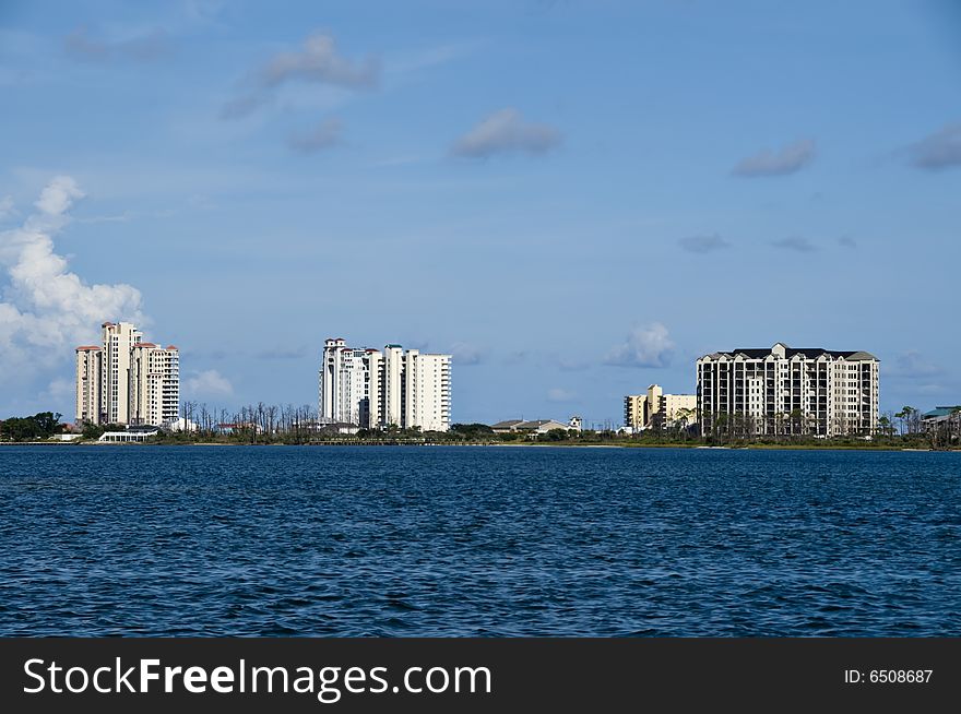 View of a series of high rise condos by the sea in a resort or vacation area.