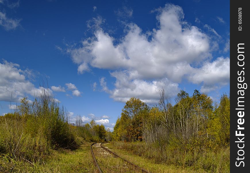 A summer landscape with an old railway track