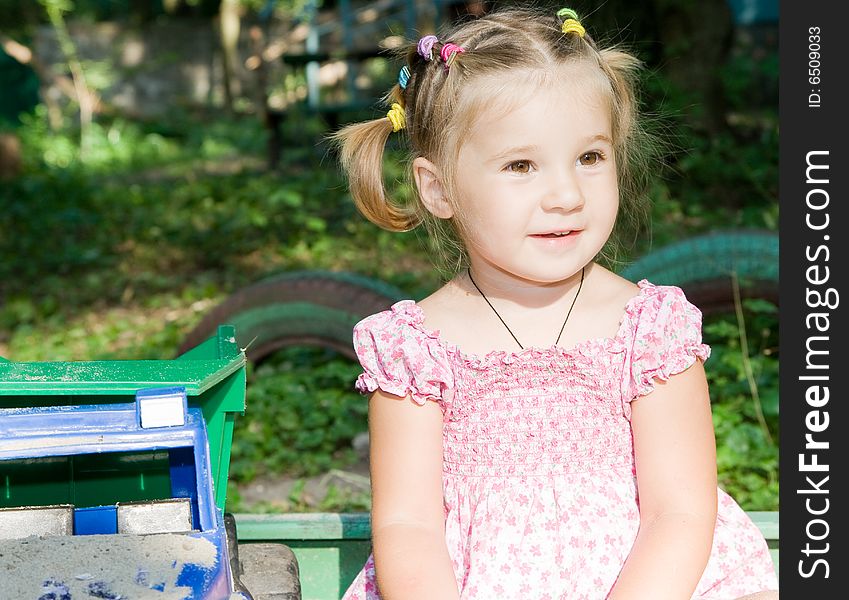 Little girl playing in sandbox