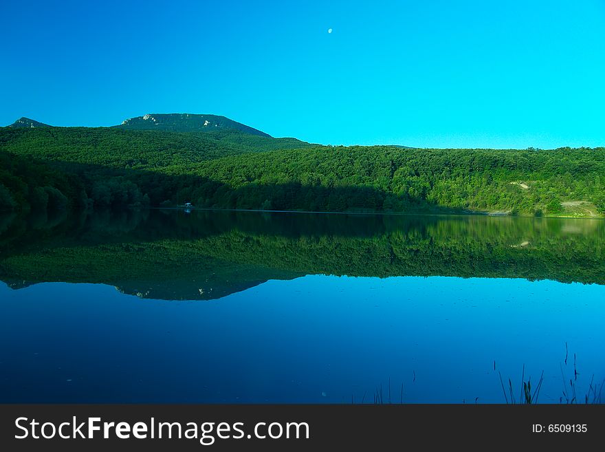 Mountain lake in Crimea at early morning . Mountain lake in Crimea at early morning .