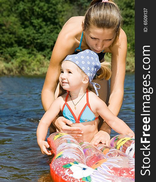 Little girl with mother in river