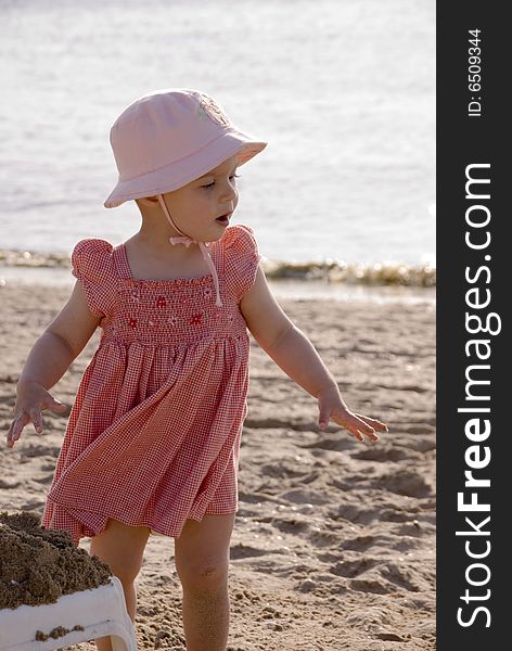 Little girl with red dress on the beach. Little girl with red dress on the beach