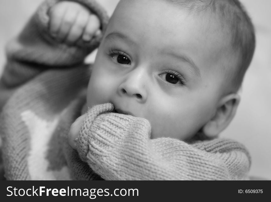 Beautiful baby boy Teething on his hand