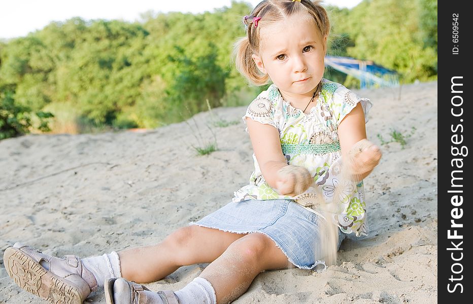 Girl playing with sand outdoor