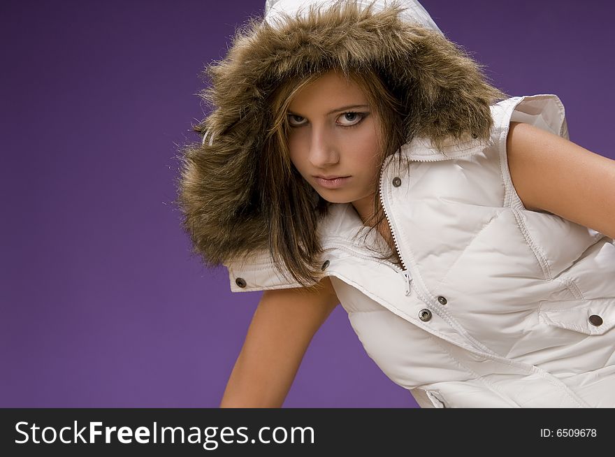 Young female teenager wearing warm white jacket without sleeves. Young female teenager wearing warm white jacket without sleeves